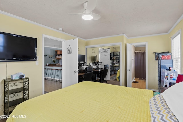 bedroom with crown molding, a closet, and wood finished floors