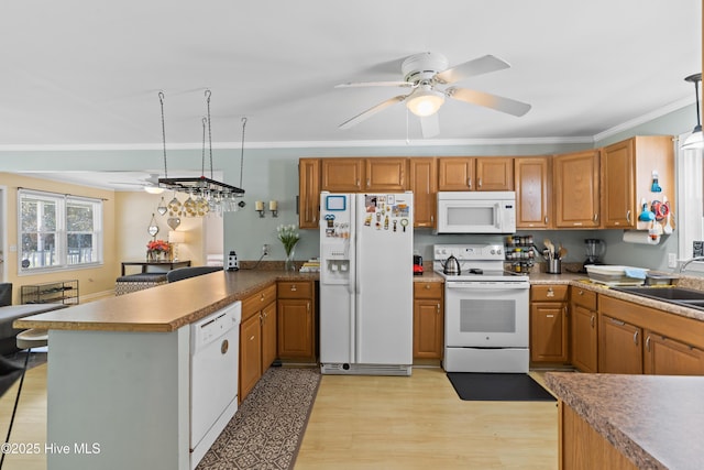kitchen featuring a sink, ceiling fan, white appliances, a peninsula, and crown molding