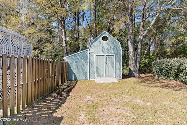 view of shed featuring fence