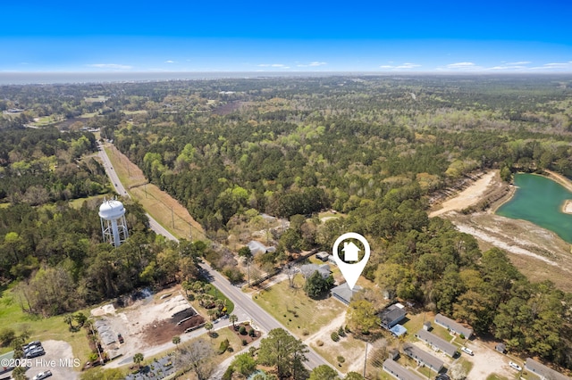 bird's eye view with a water view and a forest view