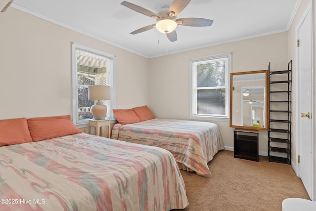carpeted bedroom with baseboards, ornamental molding, and ceiling fan