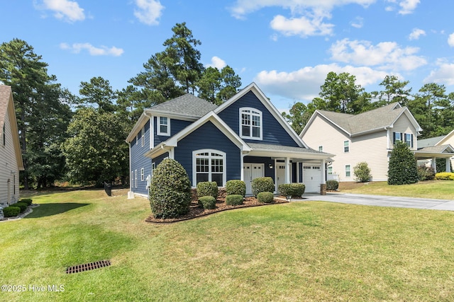 view of front of property featuring a front lawn, driveway, and roof with shingles