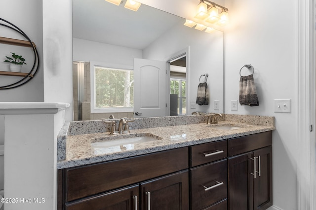 full bath with double vanity and a sink