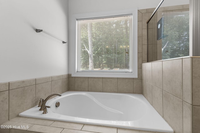 bathroom featuring a tile shower and a garden tub