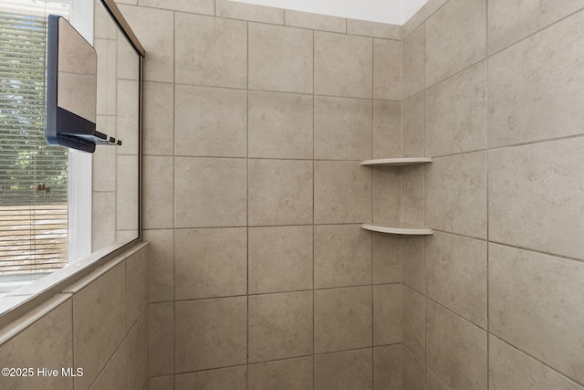 bathroom with a tile shower