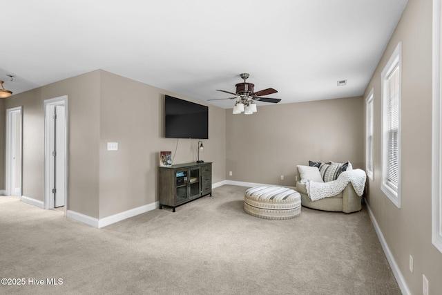 living room featuring visible vents, baseboards, ceiling fan, and carpet floors