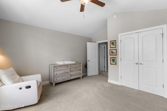 living area with carpet flooring, baseboards, lofted ceiling, and ceiling fan