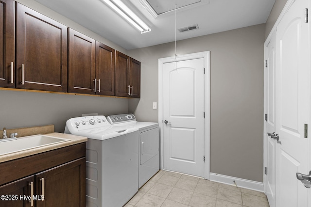 laundry area featuring visible vents, washer and clothes dryer, attic access, cabinet space, and a sink