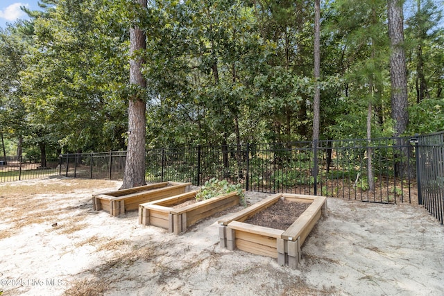 view of patio / terrace with a vegetable garden and fence