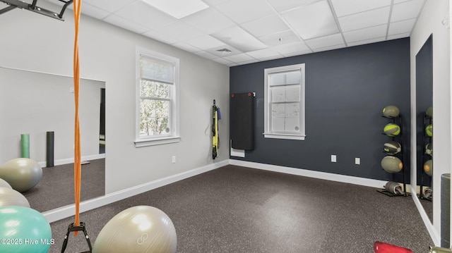 exercise room featuring a drop ceiling, baseboards, and visible vents