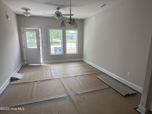 doorway to outside featuring baseboards, concrete floors, visible vents, and ceiling fan