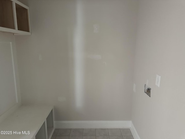laundry room with light tile patterned floors and baseboards