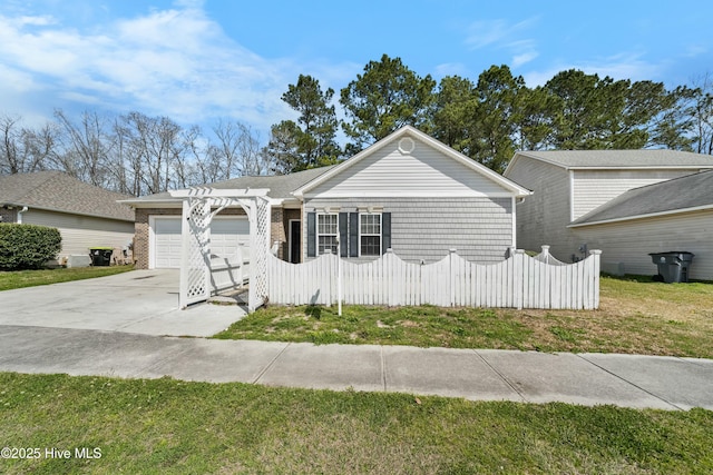 1012 Lake Norman Ln, Leland, NC 28451 - ranch-style home featuring a front lawn, driveway, fence, and a garage