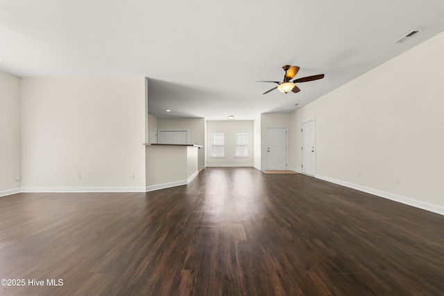 1012 Lake Norman Ln, Leland, NC 28451 - unfurnished living room featuring visible vents, a ceiling fan, baseboards, and dark wood-type flooring