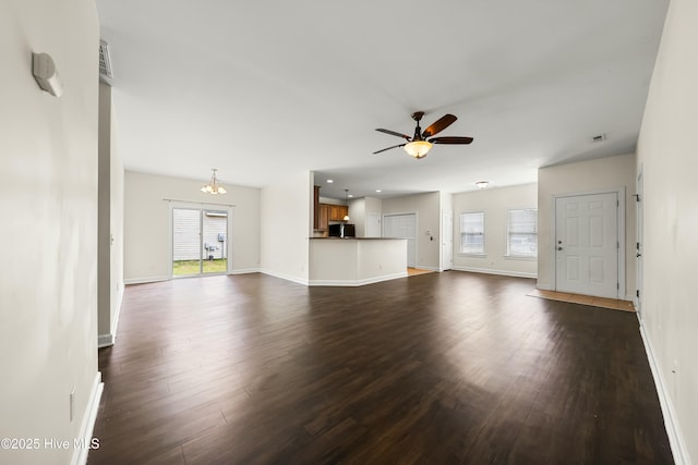 1012 Lake Norman Ln, Leland, NC 28451 - unfurnished living room featuring dark wood finished floors, plenty of natural light, a ceiling fan, and baseboards