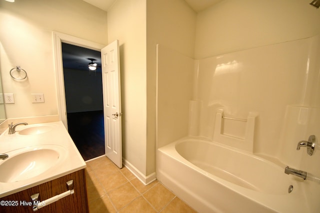 bathroom with tile patterned floors, double vanity, washtub / shower combination, and a sink