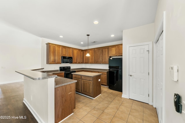 1012 Lake Norman Ln, Leland, NC 28451 - kitchen featuring brown cabinets, a peninsula, a center island, and black appliances