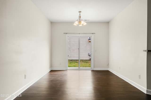1012 Lake Norman Ln, Leland, NC 28451 - empty room with visible vents, baseboards, dark wood-style floors, and a chandelier