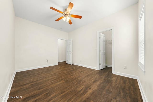 1012 Lake Norman Ln, Leland, NC 28451 - unfurnished bedroom featuring a ceiling fan, baseboards, and dark wood-style flooring