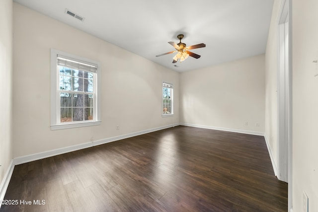 1012 Lake Norman Ln, Leland, NC 28451 - empty room with visible vents, a ceiling fan, baseboards, and dark wood-style flooring
