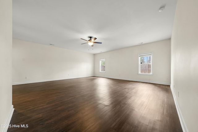 1012 Lake Norman Ln, Leland, NC 28451 - spare room featuring dark wood finished floors, a ceiling fan, and baseboards