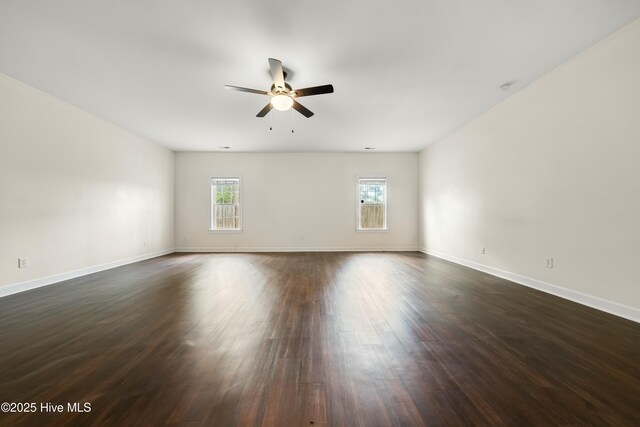 1012 Lake Norman Ln, Leland, NC 28451 - unfurnished room featuring a ceiling fan, baseboards, a wealth of natural light, and dark wood finished floors