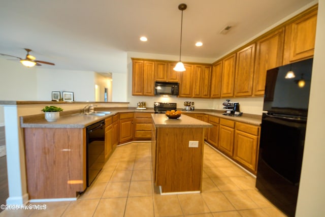 kitchen with a kitchen island, a peninsula, a sink, black appliances, and brown cabinets