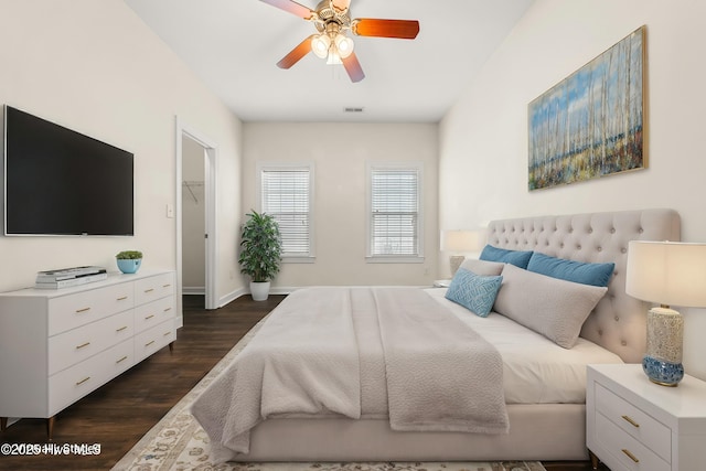 1012 Lake Norman Ln, Leland, NC 28451 - bedroom with visible vents, a walk in closet, dark wood-style flooring, baseboards, and ceiling fan
