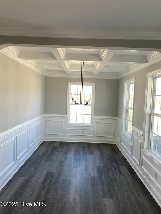 unfurnished dining area with a notable chandelier, plenty of natural light, arched walkways, and dark wood-style flooring