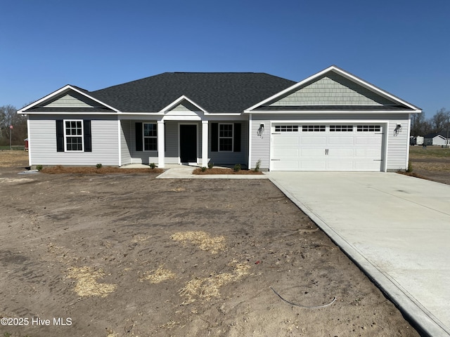 view of front of property featuring driveway and a garage