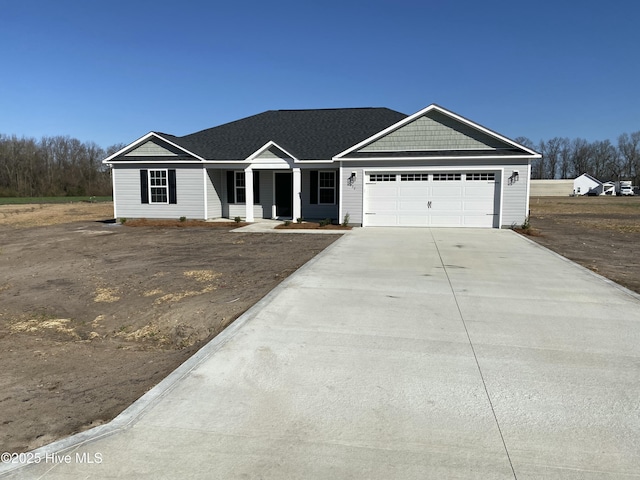 view of front of home featuring concrete driveway and an attached garage