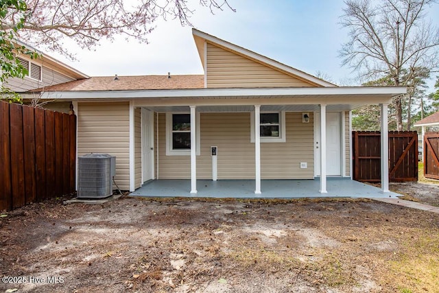 back of house featuring cooling unit and fence