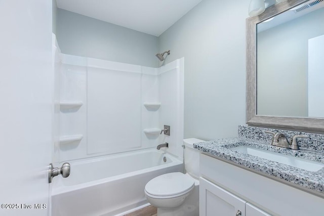 bathroom with visible vents, toilet,  shower combination, and vanity