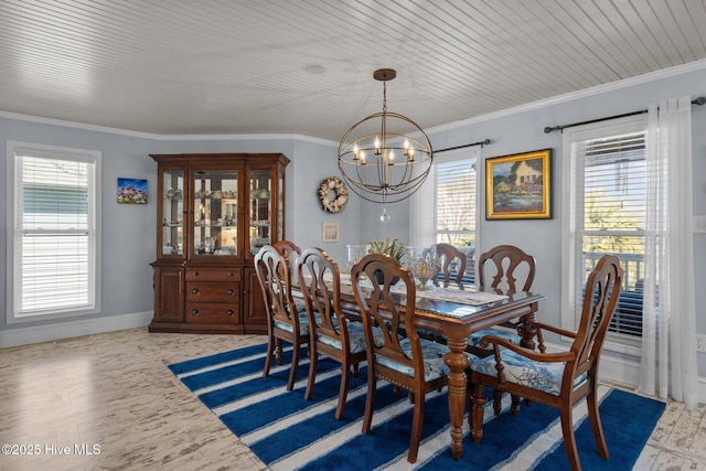 dining room featuring a chandelier, crown molding, and baseboards