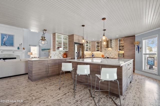 kitchen featuring tasteful backsplash, a fireplace, stainless steel fridge with ice dispenser, glass insert cabinets, and light countertops