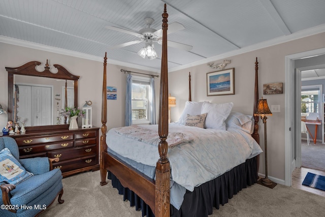 bedroom with light carpet, baseboards, crown molding, and a ceiling fan