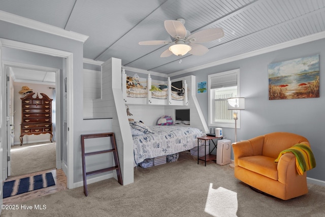 carpeted bedroom with baseboards, ornamental molding, and a ceiling fan