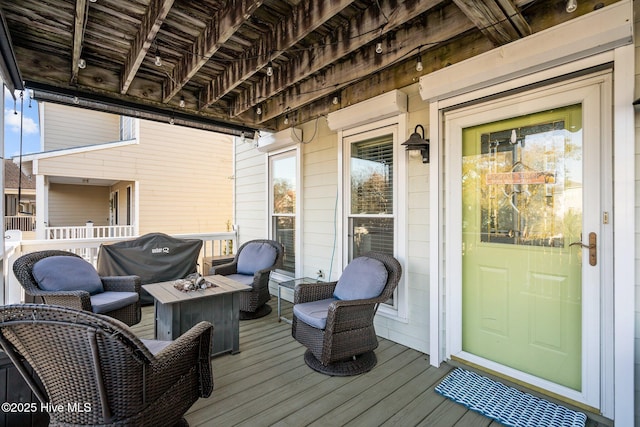 deck featuring area for grilling and a wall mounted air conditioner