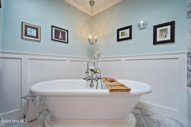 full bathroom featuring a soaking tub, wainscoting, marble finish floor, and ornamental molding