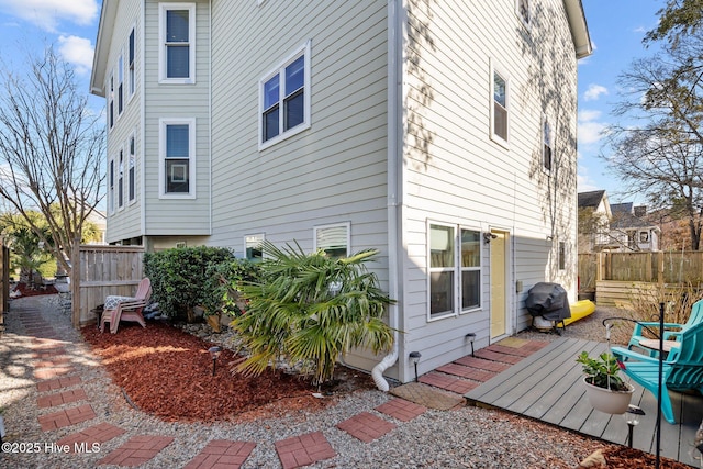 back of house with a wooden deck and fence