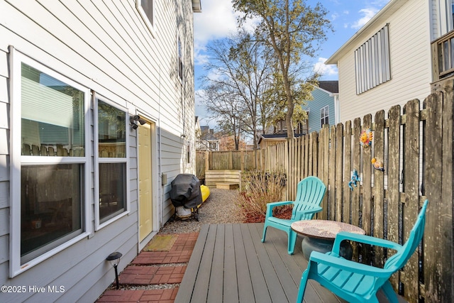 wooden terrace featuring fence