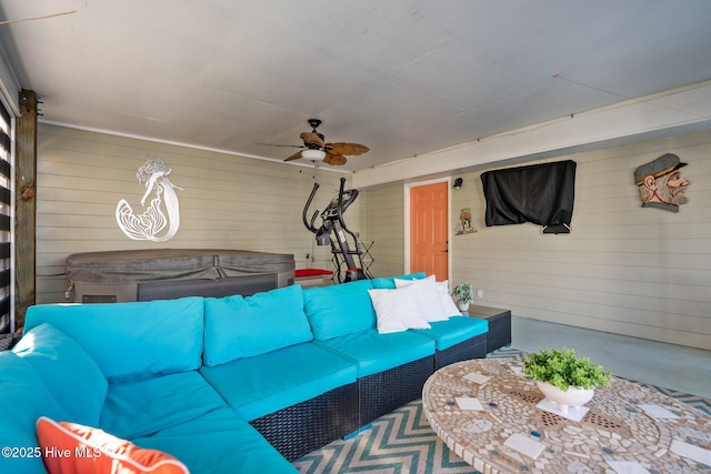 living room with concrete flooring and ceiling fan