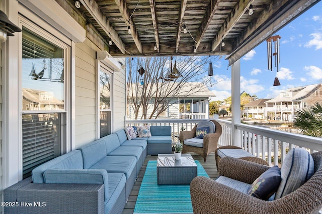 wooden deck featuring an outdoor living space and a residential view