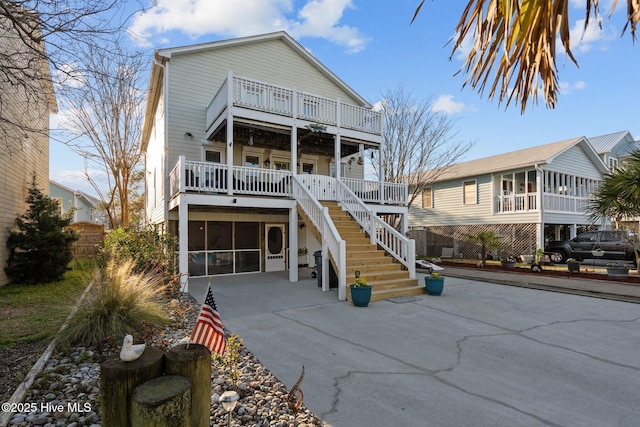 view of front of home with driveway and stairs