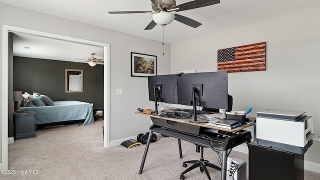 carpeted office featuring baseboards and a ceiling fan