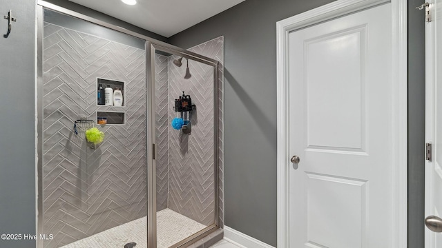 full bathroom with baseboards and a stall shower