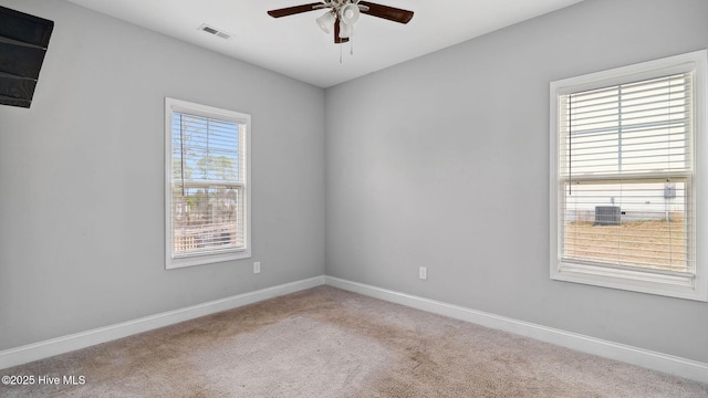 unfurnished room featuring visible vents, baseboards, carpet, and a ceiling fan