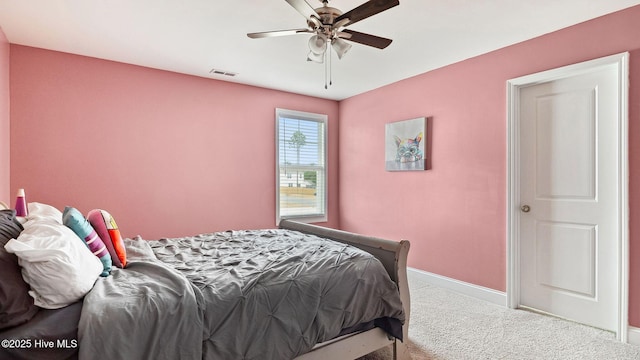 bedroom featuring visible vents, baseboards, carpet, and a ceiling fan