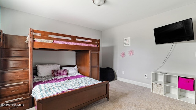 carpeted bedroom featuring baseboards