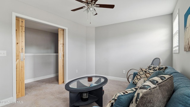 sitting room with carpet flooring, baseboards, and ceiling fan